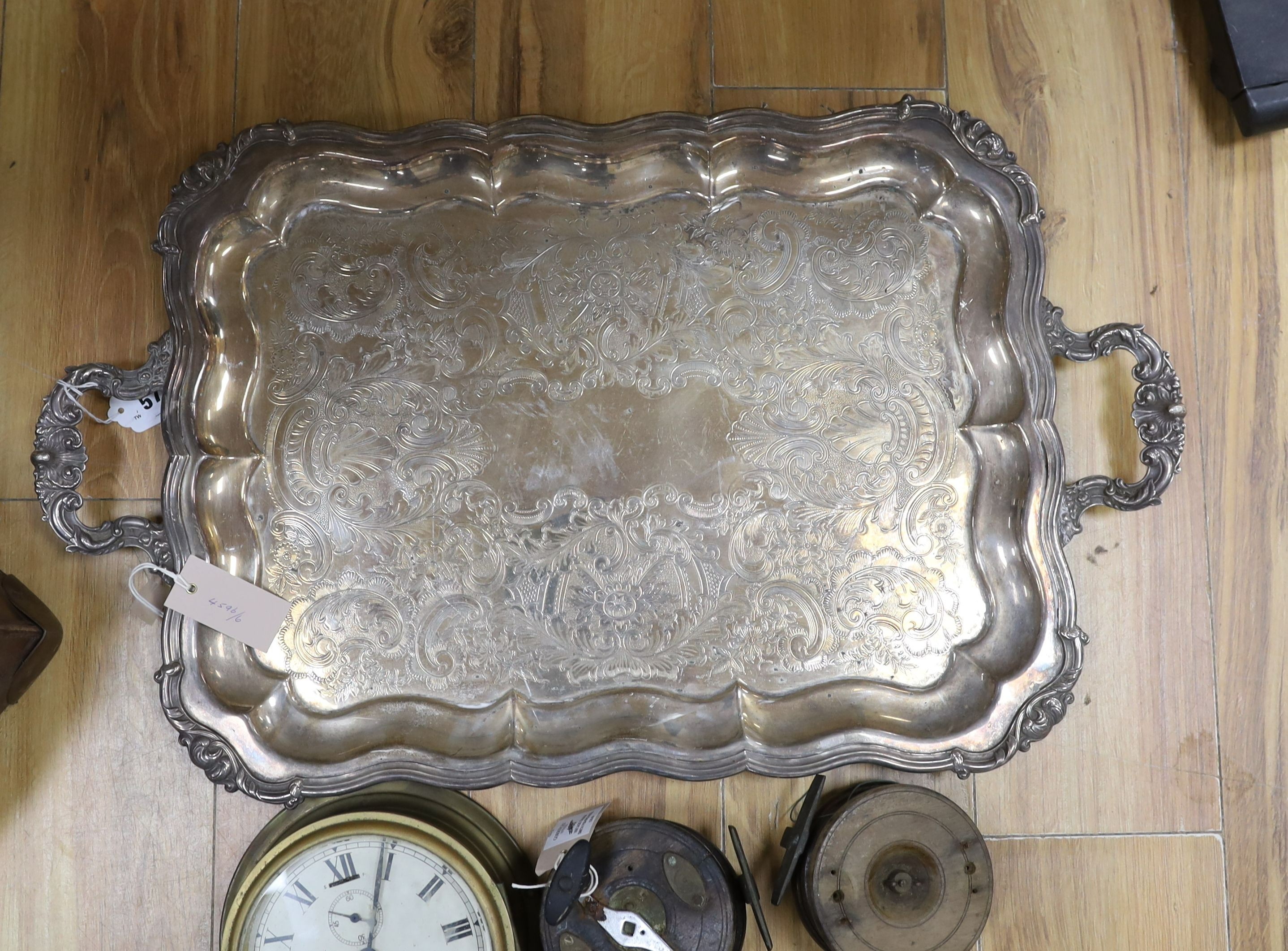 A 19th century amboyna box, 22cm wide, a Sestrel ship's wall clock, no key - 20cm diameter, a large plated two-handled tray - 71cm long, Vintage Ogden Smith fishing reel together with another (5)